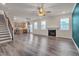 Open-concept living area with hardwood floors, fireplace, kitchen and stairway at 205 Loxton St, Fuquay Varina, NC 27526