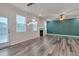 Bright living room with a fireplace, new floors, modern lighting, and access to the backyard at 205 Loxton St, Fuquay Varina, NC 27526