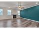 Open living room showcasing hardwood floors, a fireplace, and natural light from multiple windows at 205 Loxton St, Fuquay Varina, NC 27526