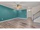 Spacious living room boasting hardwood floors, a modern ceiling fan, and ample natural light at 205 Loxton St, Fuquay Varina, NC 27526