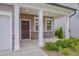 Covered front porch showcasing stone accents, white columns, and a well-kept lawn at 205 Loxton St, Fuquay Varina, NC 27526