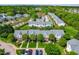 An aerial view of a residential neighborhood with well-maintained lawns, mature trees and ample parking spaces at 2101 Piney Brook Rd # 105, Raleigh, NC 27614