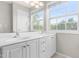 Bathroom with a double sink vanity, a large mirror, and natural light at 2101 Piney Brook Rd # 105, Raleigh, NC 27614