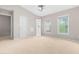Spacious bedroom with two windows, neutral carpet, and an ensuite bathroom at 2101 Piney Brook Rd # 105, Raleigh, NC 27614
