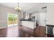 Well-lit kitchen with stainless steel appliances, granite countertops, and hardwood floors at 2101 Piney Brook Rd # 105, Raleigh, NC 27614
