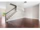 Open living room with hardwood floors, staircase, and views to the backyard at 2101 Piney Brook Rd # 105, Raleigh, NC 27614