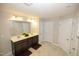Bathroom featuring a double sink vanity, large mirror, and ample cabinet space with neutral colored walls at 2123 Gregor Overlook Ln, Apex, NC 27502
