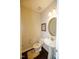 Cozy half bathroom featuring a pedestal sink, oval mirror, and neutral decor at 2123 Gregor Overlook Ln, Apex, NC 27502