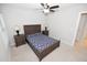 Cozy bedroom featuring a ceiling fan, complemented by a bed with wooden frame and matching nightstands at 2123 Gregor Overlook Ln, Apex, NC 27502