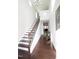 Bright entryway with hardwood floors, staircase, and a view into the living area at 2123 Gregor Overlook Ln, Apex, NC 27502