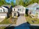 Beautiful two-story home with a well-manicured lawn, mature trees, and a two-car garage at 2123 Gregor Overlook Ln, Apex, NC 27502