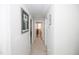 Bright hallway featuring carpeted floors, artwork, and white walls at 2123 Gregor Overlook Ln, Apex, NC 27502