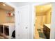 Hallway with access to laundry room with modern washer/dryer and full bathroom with shower and tub combo at 2123 Gregor Overlook Ln, Apex, NC 27502