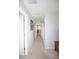 Upstairs hallway featuring carpeted floors, white walls, and access to multiple rooms at 2123 Gregor Overlook Ln, Apex, NC 27502