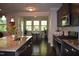 Open kitchen with granite counters, stainless appliances, and an adjacent dining area with large windows at 2123 Gregor Overlook Ln, Apex, NC 27502