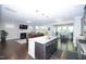 Open-concept kitchen and living area featuring granite countertops and stainless steel appliances at 2123 Gregor Overlook Ln, Apex, NC 27502