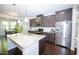 Modern kitchen featuring stainless steel appliances, granite countertops, and dark wood cabinetry at 2123 Gregor Overlook Ln, Apex, NC 27502