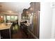 Contemporary kitchen with stainless steel appliances, dark cabinets, and an island with granite countertop at 2123 Gregor Overlook Ln, Apex, NC 27502