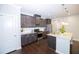 Well-equipped kitchen with dark wood cabinets, stainless steel appliances, and a center island at 2123 Gregor Overlook Ln, Apex, NC 27502