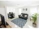 Upstairs living room, featuring a modern desk, plush sofa, and bright light at 2123 Gregor Overlook Ln, Apex, NC 27502