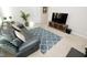Comfortable living room featuring a plush sofa, modern rug, and entertainment center at 2123 Gregor Overlook Ln, Apex, NC 27502