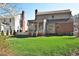 Expansive backyard with lush green lawn, mature trees, and a screened porch, perfect for outdoor enjoyment and relaxation at 228 Old Colony Way, Rocky Mount, NC 27804
