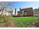 Lovely backyard with mature trees, a green lawn, and a screened porch, creating a serene and private outdoor space at 228 Old Colony Way, Rocky Mount, NC 27804