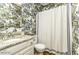 A full bathroom with unique blue patterned wallpaper, white cabinetry and shower with tub at 228 Old Colony Way, Rocky Mount, NC 27804