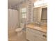 A full bathroom with wallpaper, a window, a shower and vanity with granite countertop at 228 Old Colony Way, Rocky Mount, NC 27804
