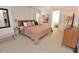 Cozy bedroom with neutral carpet, modern furniture, and a large window with natural light at 228 Old Colony Way, Rocky Mount, NC 27804