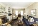 Open-concept living room with a brick fireplace, a comfortable seating arrangement, and warm lighting at 228 Old Colony Way, Rocky Mount, NC 27804
