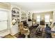 Spacious living room with ample seating, a brick fireplace, and abundant natural light at 228 Old Colony Way, Rocky Mount, NC 27804