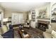 Inviting living room with a brick fireplace, built-in shelving, and hardwood floors at 228 Old Colony Way, Rocky Mount, NC 27804