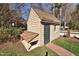 Charming outbuilding with wood siding and a shingled roof, providing extra space and character to the backyard at 228 Old Colony Way, Rocky Mount, NC 27804