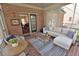 Relaxing screened porch with brick flooring and a comfortable seating area with stylish blue patterned pillows and decor at 228 Old Colony Way, Rocky Mount, NC 27804