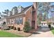 A beautifully landscaped side view of the home showcasing a brick chimney and mature trees at 228 Old Colony Way, Rocky Mount, NC 27804