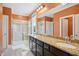 Bathroom featuring a double vanity, granite countertop, and a glass-enclosed shower at 2308 Swansea Ln, Apex, NC 27502