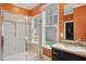 Well-lit bathroom with a granite vanity, a glass shower, and a window at 2308 Swansea Ln, Apex, NC 27502