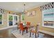 Bright dining room with stylish chairs, a modern chandelier, and access to the outdoors at 2308 Swansea Ln, Apex, NC 27502