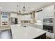Modern kitchen with white cabinets, stainless steel appliances, and a large center island at 2308 Swansea Ln, Apex, NC 27502