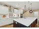 Well-lit kitchen with white cabinetry, stainless steel appliances, and a large center island at 2308 Swansea Ln, Apex, NC 27502