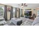 Comfortable living room featuring large windows, gray seating, and modern entertainment setup at 2308 Swansea Ln, Apex, NC 27502