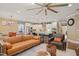 Open-concept living space with a comfortable sofa, kitchen island, and stainless steel appliances at 2308 Swansea Ln, Apex, NC 27502