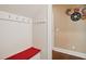 Mudroom with a built-in bench, hooks for hanging items, and modern decor at 2308 Swansea Ln, Apex, NC 27502