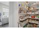 Well-stocked pantry with organized shelves and storage baskets offering ample space for groceries at 2308 Swansea Ln, Apex, NC 27502