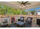 Relaxing covered porch with ceiling fan, cushioned chairs, and blue patterned rug for outdoor comfort at 2308 Swansea Ln, Apex, NC 27502