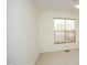 Minimalist bedroom with neutral carpet, a window with wood blinds, and white walls at 233 Sweet Bay Pl, Carrboro, NC 27510