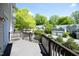Spacious deck with brown railing and a view of neighboring homes and lush greenery at 233 Sweet Bay Pl, Carrboro, NC 27510