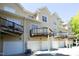 Multi-story home with multiple garage doors and balconies, perfect for outdoor relaxation and storage at 233 Sweet Bay Pl, Carrboro, NC 27510