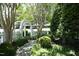 A tranquil garden with a white arbor and lush greenery creating a serene escape at 233 Sweet Bay Pl, Carrboro, NC 27510